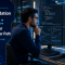 A machine learning engineer focused on PyTorch code on multiple screens, symbolizing career growth with the Linux Foundation PTCA certification.